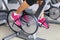 Exercise bike with spinning wheels - woman biking