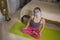 Exercise during covid-19 virus home quarantine - young beautiful and happy Asian Chinese woman in protective mask doing yoga