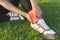 Exercise and healthy concept, Young woman asian have accident ankle twist sprain in sport exercise jogging, selective focus