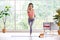 Exercise online training class at home, Healthy asian woman with headphone while workout fitness by digital tablet  in living room