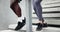 Exercise, running and legs on stairs with people together for wellness, workout or cardio closeup. Fitness, sports and
