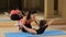 Exercise to strengthen back muscles. Training beautiful curly girls. Gymnastics coach helping exercise. coaching a