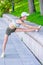 exercises on the city embankment, a female athlete stretches and warms up her muscles before