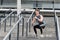 Exercising and healthy lifestyle concept. man doing squats outdoor. man with fitness watch exercising and doing squats