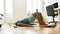 Exercising. Young active man doing exercises during morning workout with dumbbells on yoga mat at home. Sport, healthy