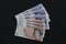 EXETER, ENGLAND - DECEMBER 20TH 2019: A fan of ten and twenty pound Sterling notes rests on a black background