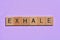 Exhale, word on mauve background