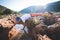 Exhausted adventurer drinks water from a crevice in a rock