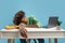 Exhausted african american male student sleeping at desk with books and laptop, guy napping at table feeling tired