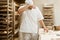 exhausted baker working with raw dough at on baking manufacture