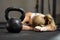 Exhausted blonde girl lying on a floor of fitness center after crossfit training