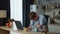 Exhausted businessman working laptop at kitchen table worried about work fail.