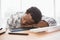 Exhausted casual businessman sleeping on desk