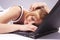 Exhausted Caucasian blond Woman With Laptop. Laying Face Down