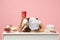 Exhausted chef cook confectioner or baker in white t-shirt, toque chefs hat laid her head down on table sit work at desk