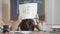 Exhausted cute schoolboy putting head on desk and raising Help written on paper. Portrait of tired bored Caucasian boy