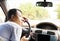 Exhausted driver resting on steering wheel