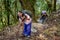 Exhausted female adventurers with backpacks and hiking poles