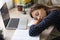 Exhausted female student fall asleep at desk studying