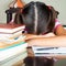 Exhausted girl sleeping on her desk