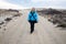 Exhausted hiker on the beach, walks wearing a winter jacket, ready to be finished with the hike on Cape Cod National Seashore