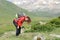 Exhausted hiker resting in a high mountain field