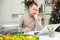 Exhausted male office worker sitting at his desk in Christmas decorated office