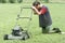 Exhausted Man with Lawn Mower