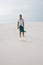 Exhausted man, lost in the desert, is walking along the dune