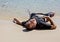 Exhausted man lying on the beach