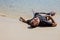 Exhausted man lying on the sea beach