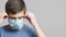 Exhausted medical worker put on medical and go working hard mask on a gray studio background, concept medicine effort, fight for l