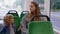 Exhausted mother fall asleep and missed stop station in tram, kid daughter wakes tired sleepy woman