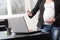 Exhausted pregnant woman in front of her laptop