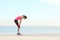 Exhausted runner resting on the beach after exercise