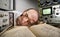 Exhausted scientist sleeping on book