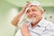 Exhausted senior is drying his forehead after sport