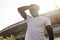 Exhausted sportsman in white t-shirt standing outdoors