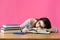 Exhausted student sleeping at her desk