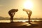 Exhausted and tired fitness couple silhouettes at sunset