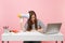 Exhausted tired woman holding leaning on megaphone sit, working on project at white desk at office with pc laptop