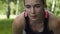 Exhausted woman runner breathes heavily, tired sportswoman outdoors slow motion