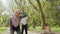 Exhausted woman in sport clothes and hijab taking break during outdoors workout. Handsome muslim guy resting on