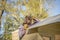 Exhausted woman working on roof of tree house