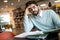 Exhausted young man student studying in a library