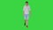 Exhausted young man suffering from heat while walking on a Green Screen, Chroma Key.