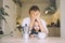 Exhausted young woman with baby is sitting with coffee in kitchen. Modern tired mom and little child after sleepless night. Life