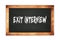 EXIT  INTERVIEW text written on wooden frame school blackboard