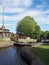 The exit lock gates at brighouse basin on the calder and hebble navigation canal with 19th century lock keepers building