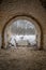 Exit from the old abandoned brick arch tunnel of the 19th century fortification in the woods. Lysa Hora, Kyiv, Ukraine